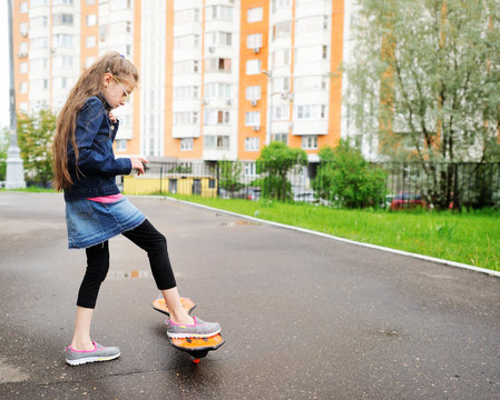 girl riding waveboard in the city street