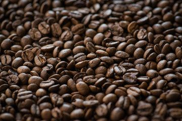 Roasted coffee beans on old wooden table
