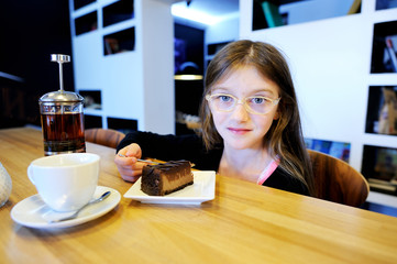 Girl having meal in cozy cafe