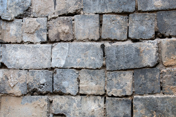 broken plaster on the wall of bricks
