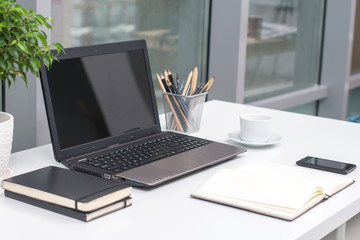 Office workplace with notebook on wood table