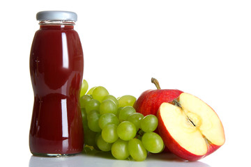 glass bottle of juice and an Apple with grapes on a white isolated background