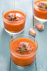 Gazpacho soup in glass on blue wood