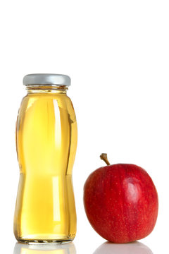 glass bottle of juice and Apple on white isolated background