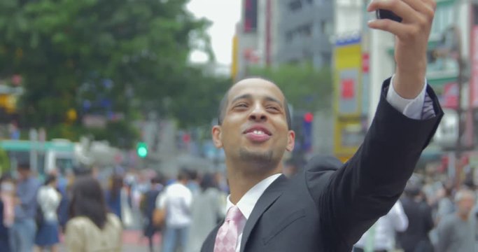 Excited International Business man face time call with friends at shibuya crossing Tokyo Japan 4K 