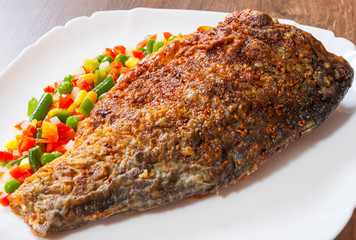 grilled fish with vegetables mix on plate