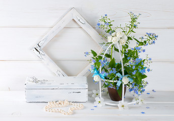 Forget-me-not flowers with birdcage and photo frame and casket w