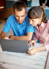 young man and woman with laptop