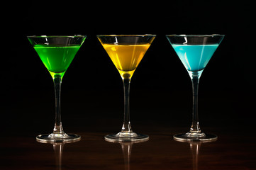 Three glasses of different alcohol cocktails