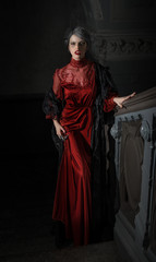 Fototapeta premium Fatal woman on stairs of old building