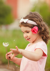 Curly girl with dandelion