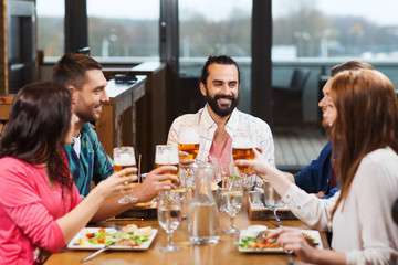 friends dining and drinking beer at restaurant