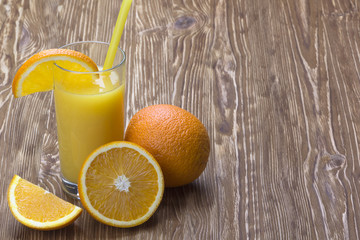 Orange juice in glass,  fresh fruits on wooden background