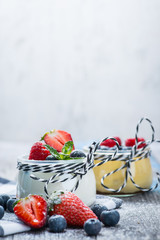 Fresh and healthy natural yogurt with berries on wooden table