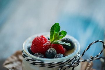 Fresh and healthy natural yogurt with berries on wooden table