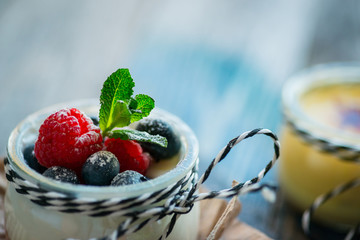 Fresh and healthy natural yogurt with berries on wooden table
