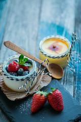 Fresh and healthy natural yogurt with berries on wooden table