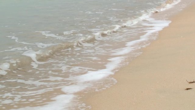 Wave comes to the sandy beach in Trincomalee, Sri Lanka.