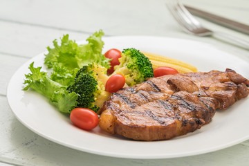 Grilled steak and vegetables on plate
