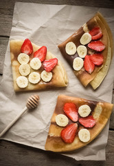 Fototapeta na wymiar pancakes with banana and strawberries