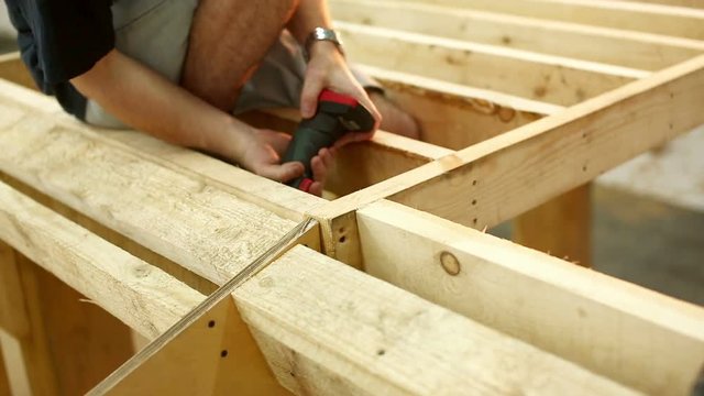 young men skaters build wooden skate park. like carpenters. Young students startup. Skateboarding without money. Builders or joiners