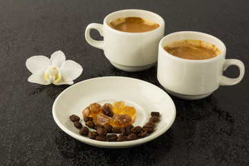 White coffee cups and white orchid