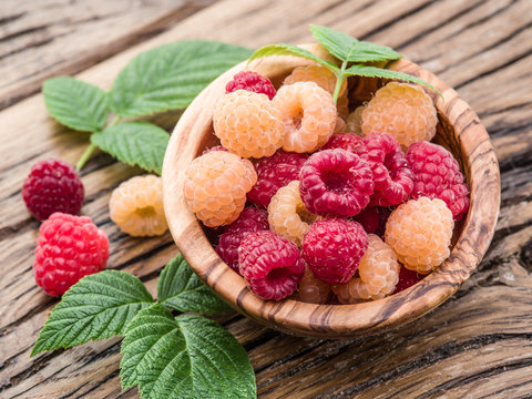 Raspberries in the wooden bowl.
