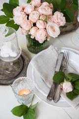 vintage wedding table decorations with roses, candles, cutlery a