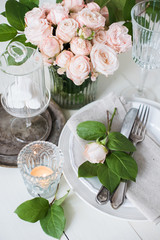 vintage wedding table decorations with roses, candles, cutlery a