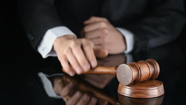 Judge. Referee hammer and a man in judicial robes