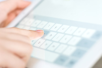 Hand touching screen on modern digital tablet pc.