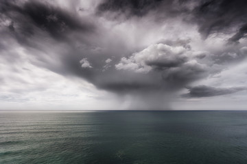 rain and stormy cloud over sea