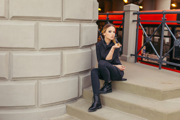 Woman sitting on the stairs with sunset