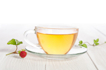 Cup of tea and strawbarries on the white wooden table