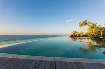infinity pool with sea views and palm trees