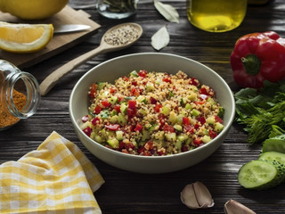 quinoa salad with vegetables for lunch on wooden table
