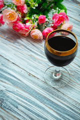 glass of red wine and flowers