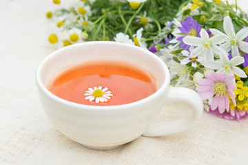 tea with chamomile and garden flowers
