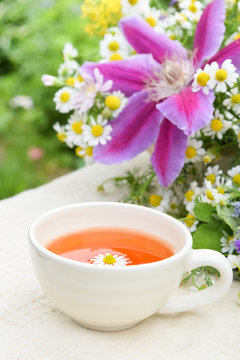 tea with chamomile and garden flowers