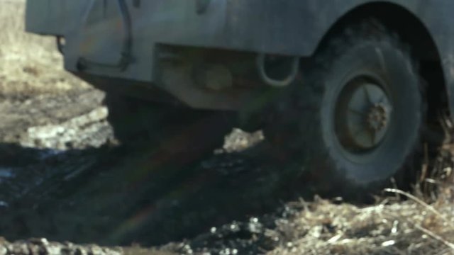 Infantry fighting vehicle rides on arable land.