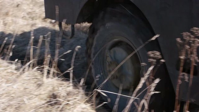 Infantry fighting vehicle rides on arable land.