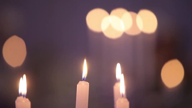 Burning candles on celebration table, dynamic change of focus