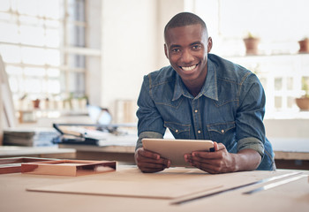 Small business owner of African descent in studio with tablet