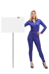 Woman standing next to a signboard © Ljupco Smokovski