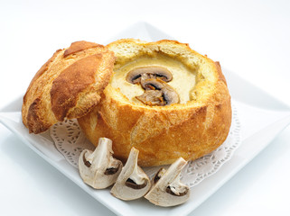 Cheese cream soup served in a loaf studio shot