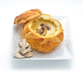 Cheese cream soup served in a loaf studio shot