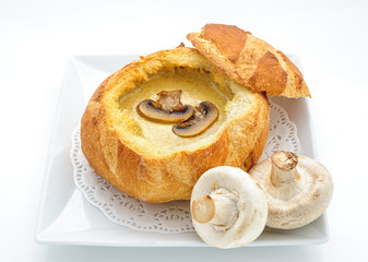 Cheese cream soup served in a loaf studio shot