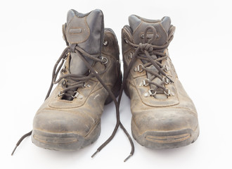 Dusty well used hiking boots isolated on white