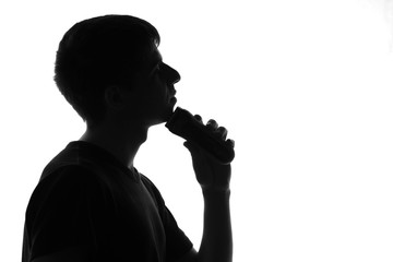 young man shaving with electric razor