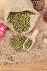 Green beans dry on wood background.